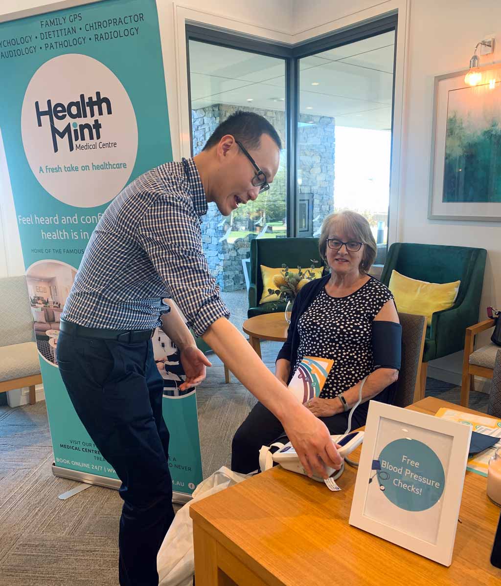 dr terence from healthmint medical centre performing a blood pressure check at berwick lifestyle community