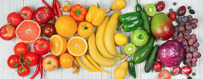 rainbow coloured vegetables and fruit all laying together